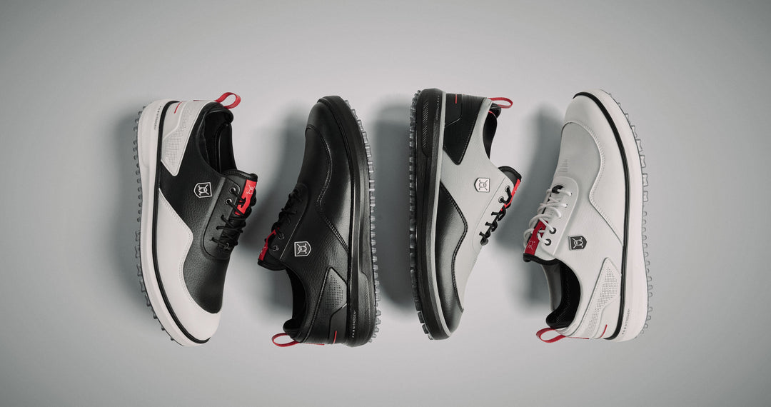 Studio product shot of four golf shoes laid on their sides in a vertical arrangement