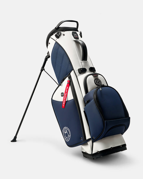 GHOSTGOLF Anyday VALOR golf bag in white and navy, standing on its integrated leg stand