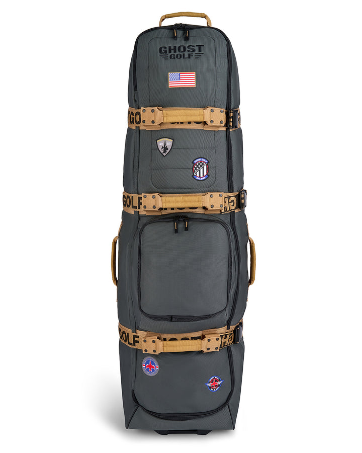 Front product shot of the G-Suit Primary AWOL Travel Bag showcasing Ghost Golf embroidery across the top panel, an embroidered USA flag detail, and custom military aviation-inspired patches throughout the exterior. Front-facing image highlighting the bag’s premium construction, spacious travel-ready design, patriotic accents, unique badge details, and signature Ghost Golf craftsmanship. #color_green