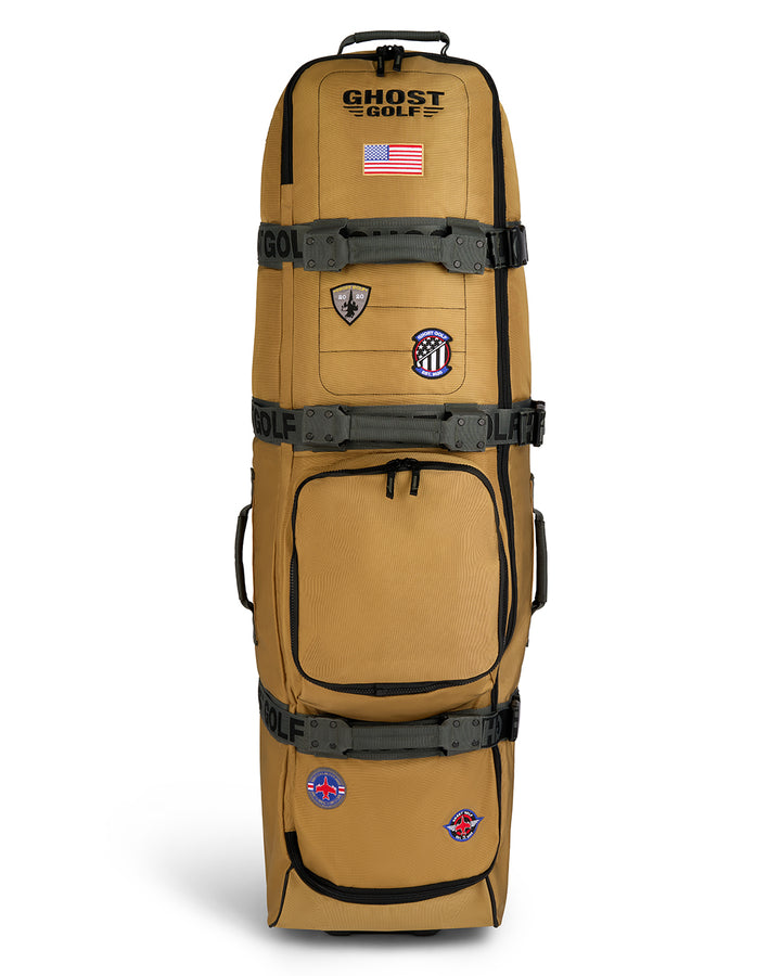 Front product shot of the G-Suit Secondary AWOL Travel Bag showcasing Ghost Golf embroidery across the top panel, an embroidered USA flag detail, and custom military aviation-inspired patches throughout the exterior. Front-facing image highlighting the bag’s premium construction, spacious travel-ready design, patriotic accents, unique badge details, and signature Ghost Golf craftsmanship. #color_sand