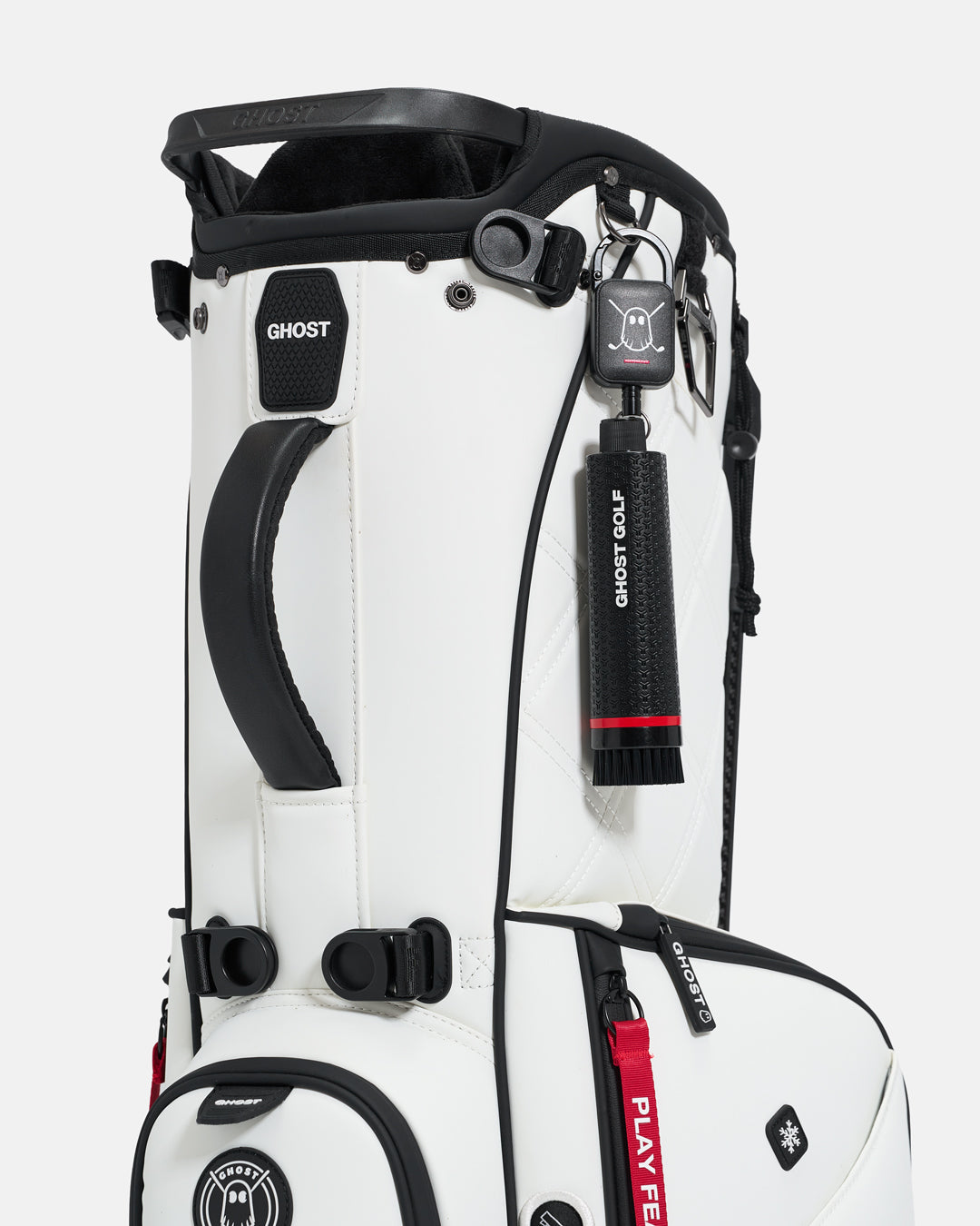 Black Ghost Golf club and shoe cleaning brush with a magnetic back, water container, and removable brush heads attached to a golf bag #color_black