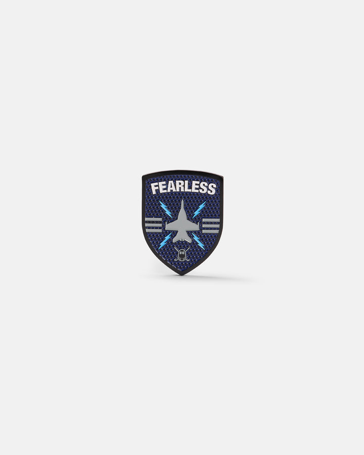Product photo of a shield-shaped ball marker featuring the word “Fearless,” a jet icon, and the Ghost Golf logo at the bottom.