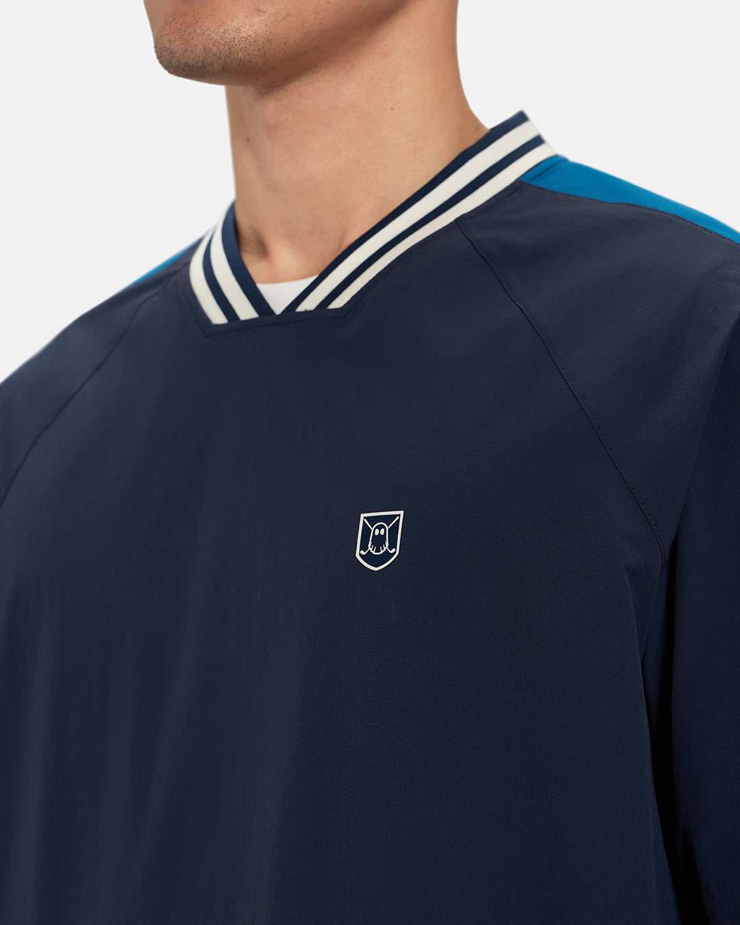 Front Closeup View of Navy Fairway Windshirt V2 on Asian Male Model with Ghost Icon Crest #color_navy