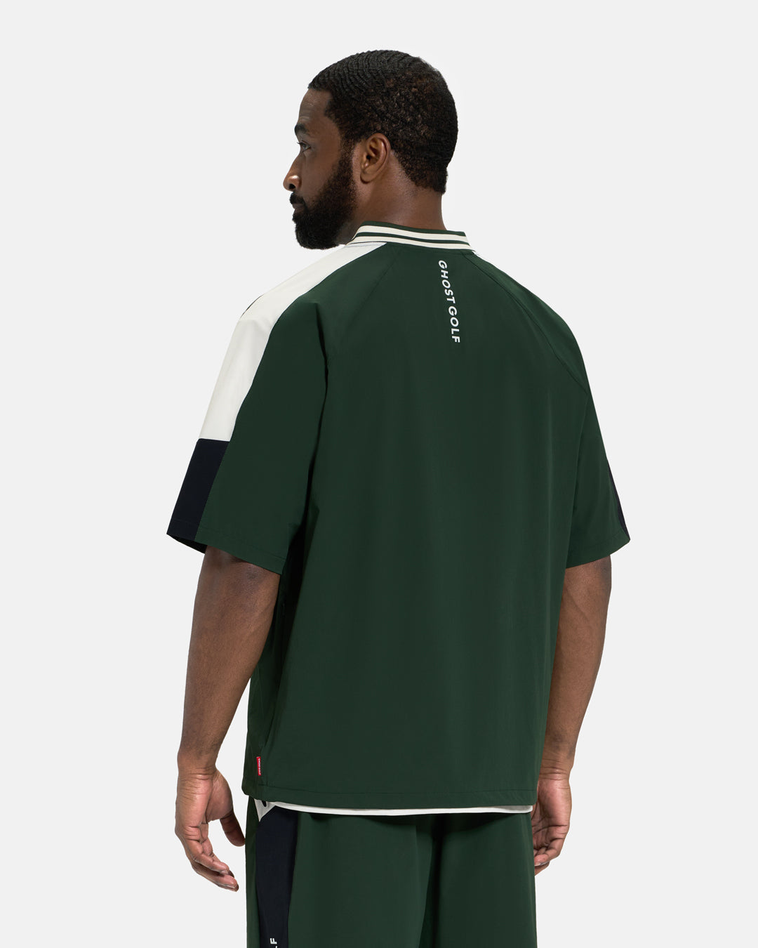 Back View of Bogey Green Fairway Windshirt V2 on Black Male Model #color_bogey-green