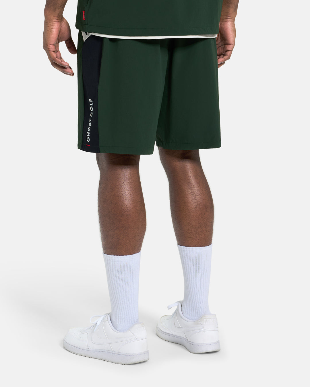 Back View of Navy Fairway Windshort V2 on Black Male Model #color_bogey-green