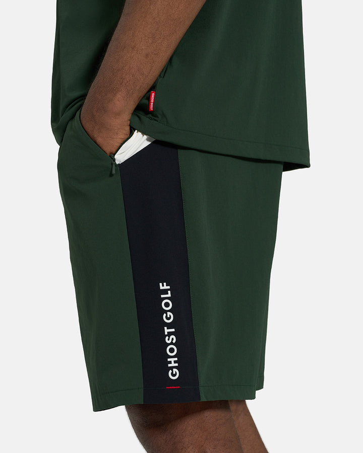 Closeup Side View of Bogey Greeb Fairway Windshort V2 on Black Male Model with hand in pocket #color_bogey-green
