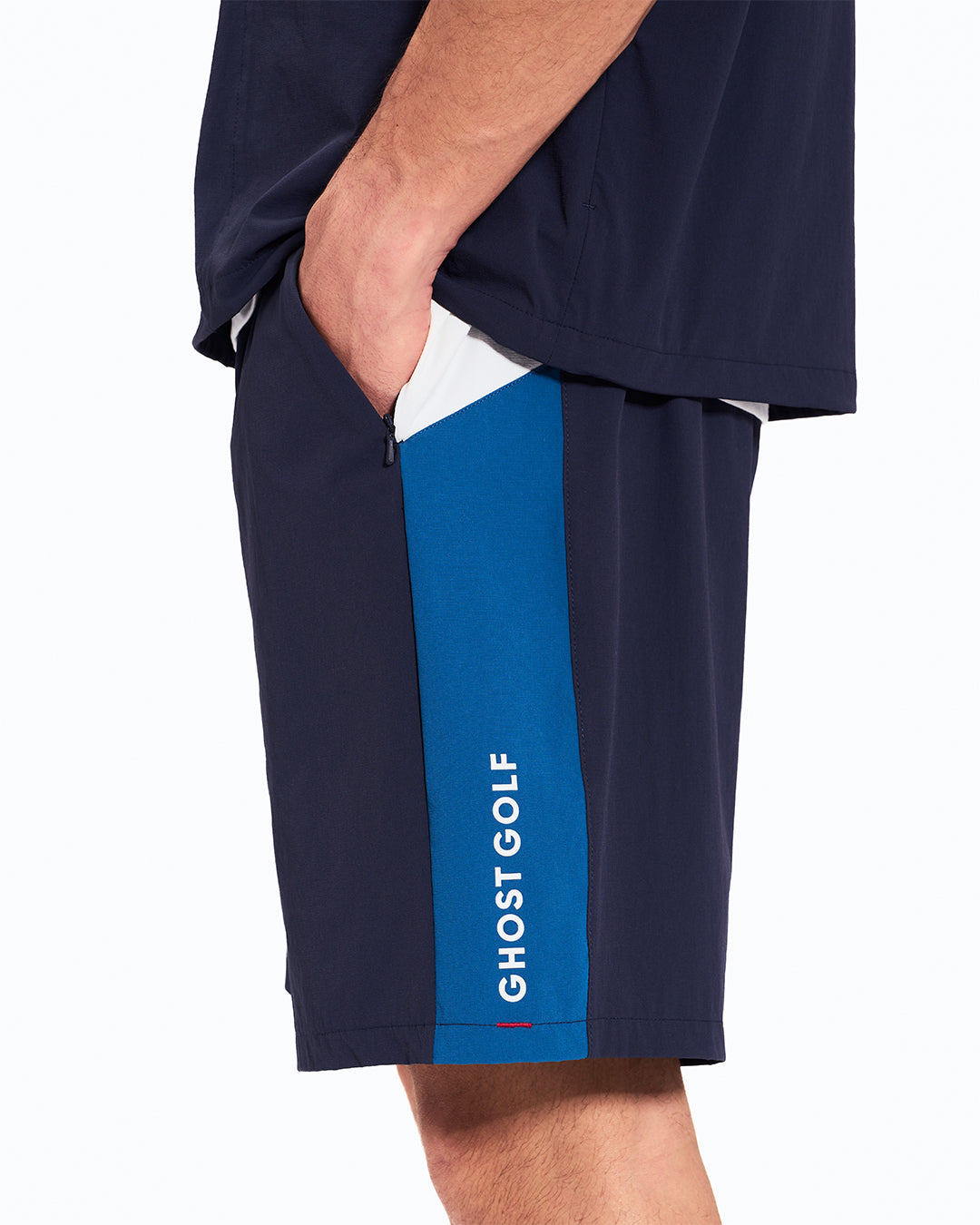 Side View of Navy Fairway Windshort V2 on Asian Male Model with hand in pocket #color_navy