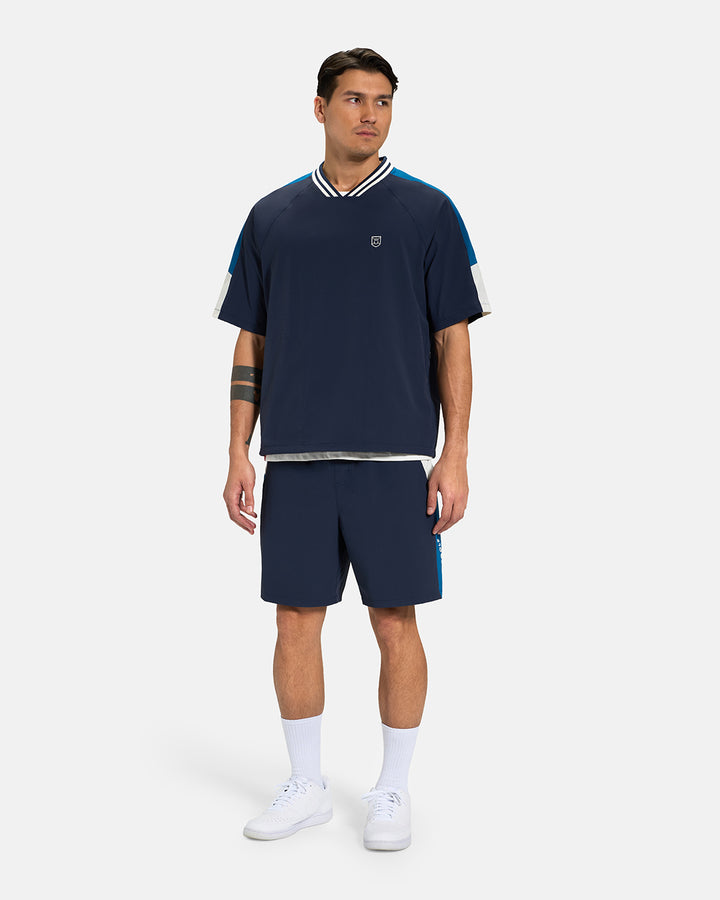 Full Body Front View of Navy Fairway Windshort V2 on Asian Male Model wearing navy shirt and white shoes #color_navy