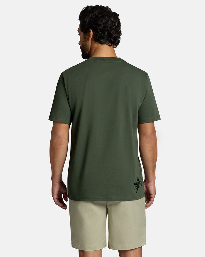 Top Back Body Shot of White Male Model Wearing Forest Shadow Flag Tee with khaki shorts. Ghost Golf Hit on the right bottom t-shirt #color_forest-shadow