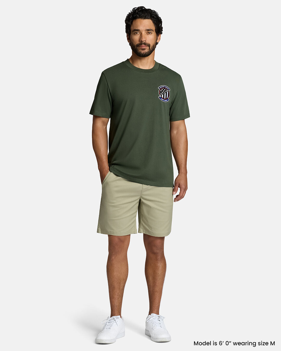 Full Front Body Shot of White Male Model Wearing Forest Shadow Flag Tee with khaki shorts and white shoes #color_forest-shadow