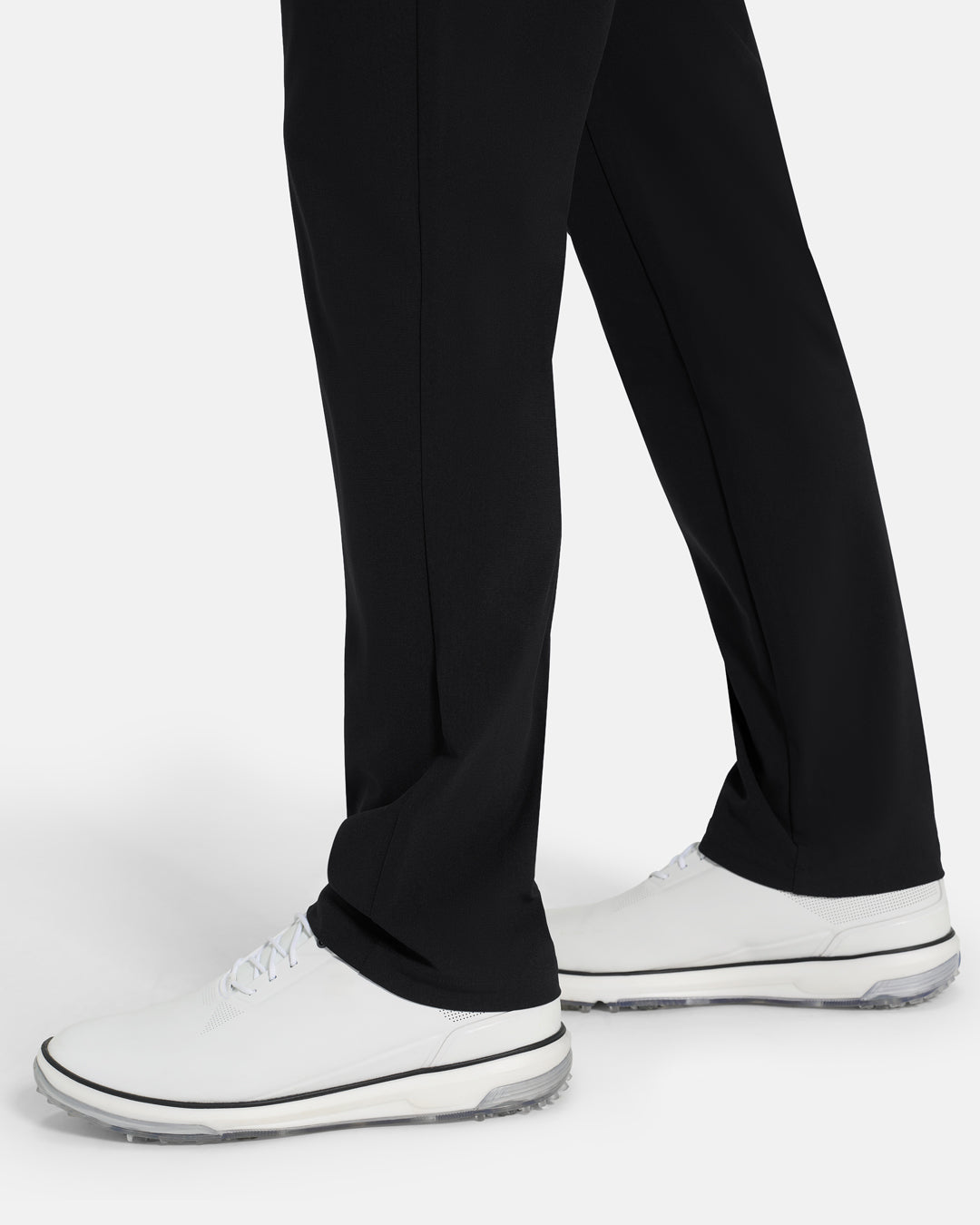 Bottom Closeup Side View of Black Ghost Golf Core 5 Pocket Pant on White male Model #color_black