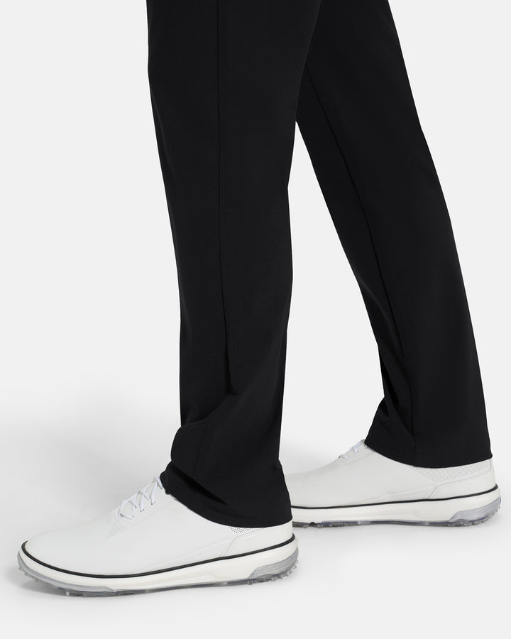 Bottom Closeup Side View of Black Ghost Golf Core 5 Pocket Pant on White male Model #color_black