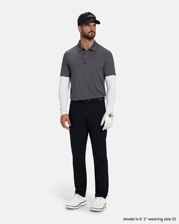 Full Body Front View of Black Ghost Golf Core 5 Pocket Pant on White Male Model wearing grey polo black belt black hat white glove and white shoes #color_black