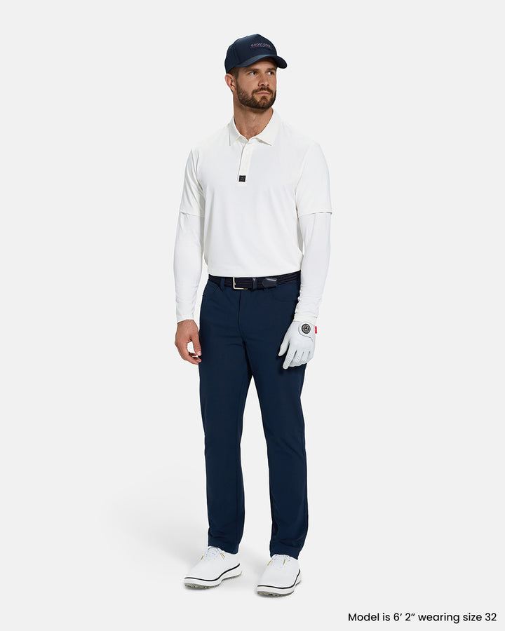 Full Body Front View of Navy Ghost Golf Core 5 Pocket Pant on White Male Model wearing white polo navy belt navy hat white glove and white shoes #color_navy