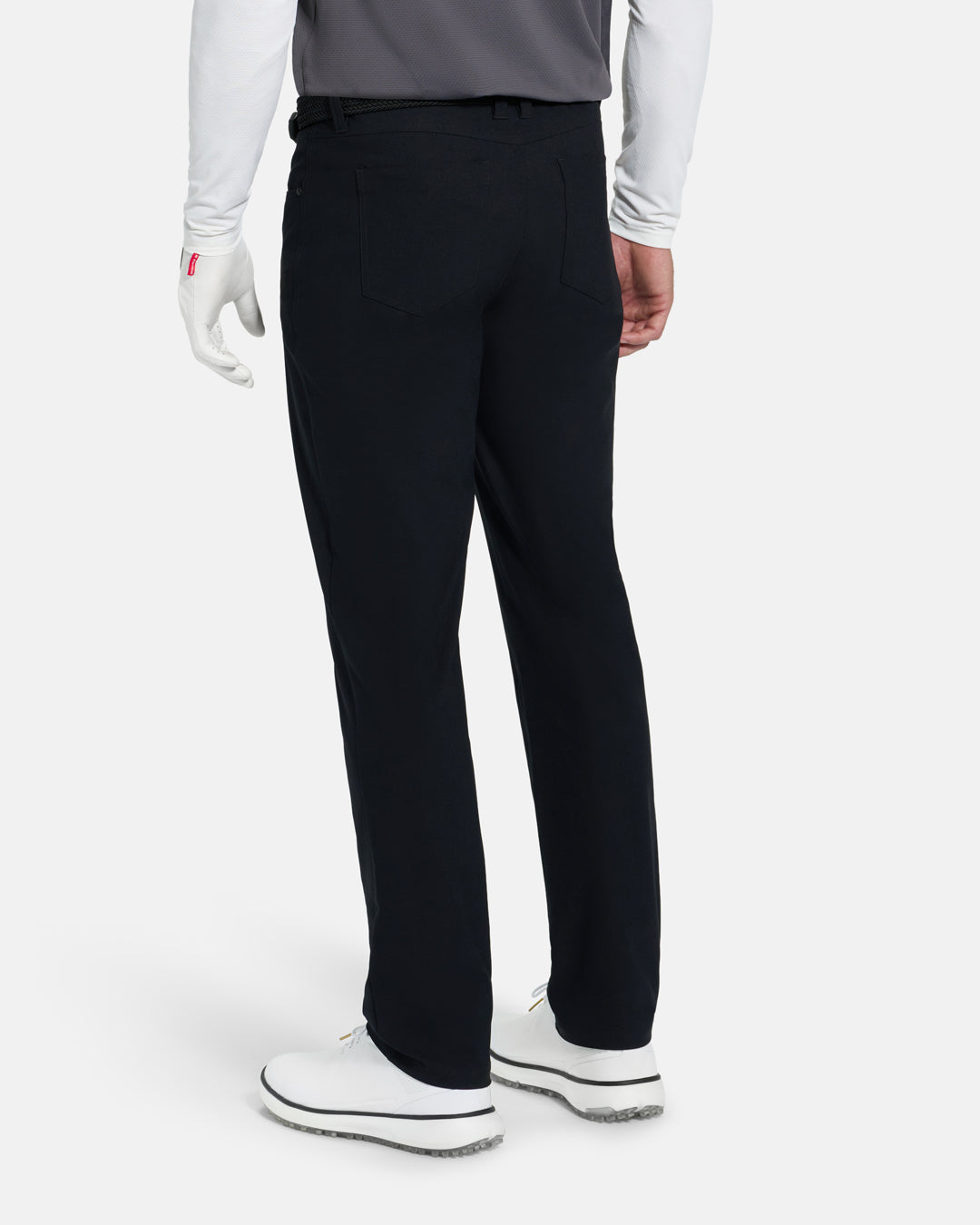 Back View of Black Ghost Golf Core 5 Pocket Pant on White Male Model with white shoes #color_black