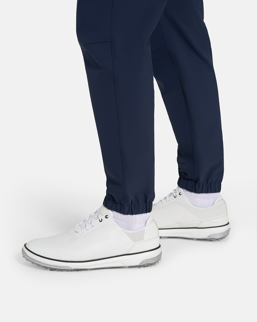 Bottom Closeup Side View of Navy Ghost Golf Core Jogger Pant on White male Model #color_navy