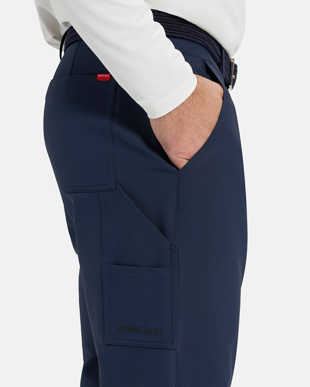 Closeup Side View of Navy Ghost Golf Core Jogger Pant on White Male Model with hand in pocket #color_navy