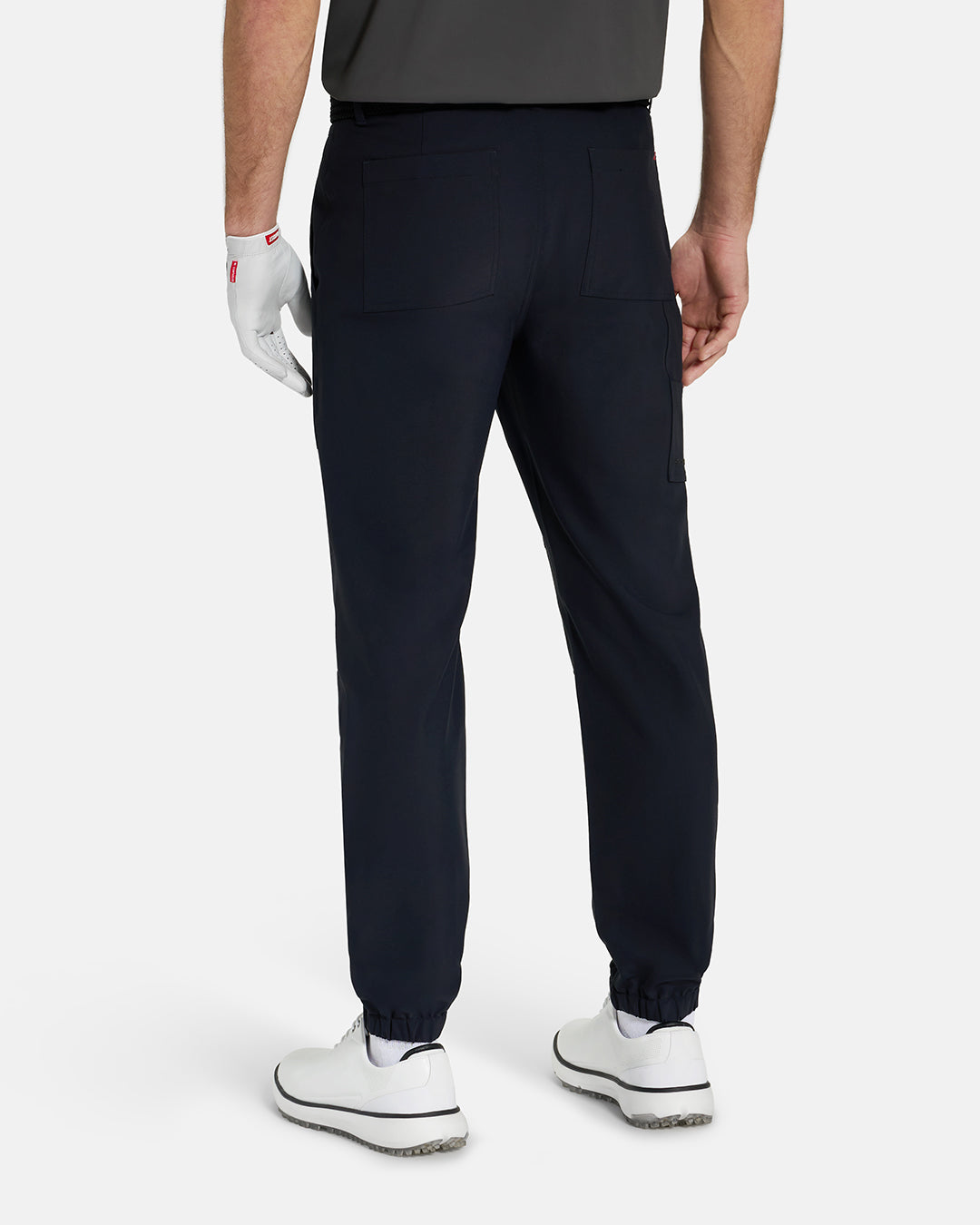 Back View of Black Ghost Golf Core Jogger Pant on White Male Model with White Shoes #color_black