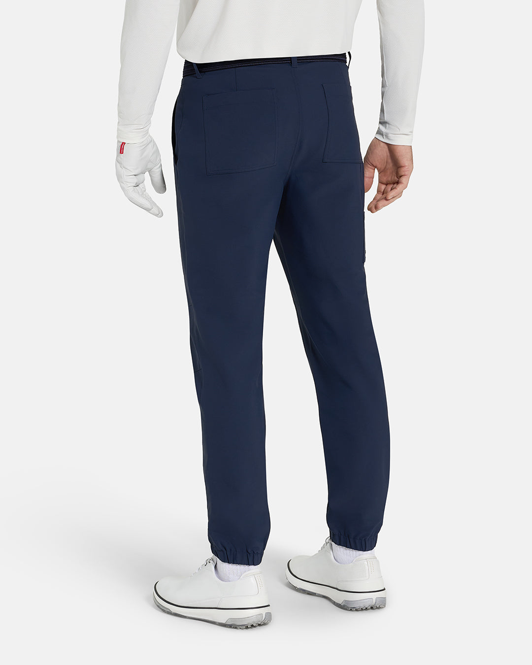 Back View of Navy Ghost Golf Core Jogger Pant on White Male Model with white shoes #color_navy