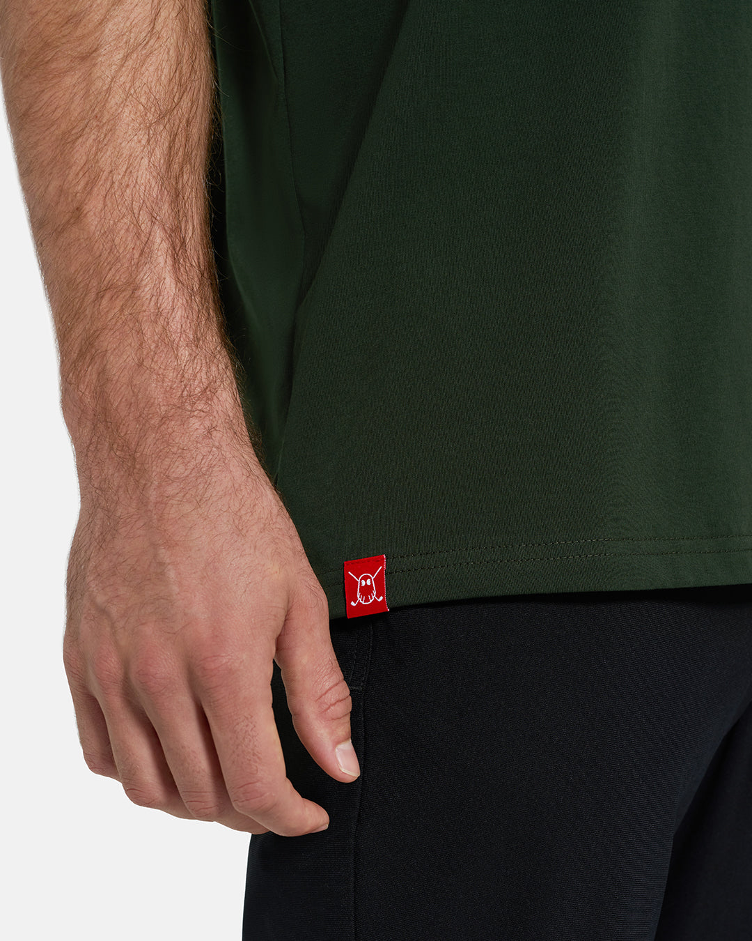 Bottom Closeup View of Forest Green Ghost Golf Core Logo Tee on White Male Model with Ghost Icon Hit #color_forest-green