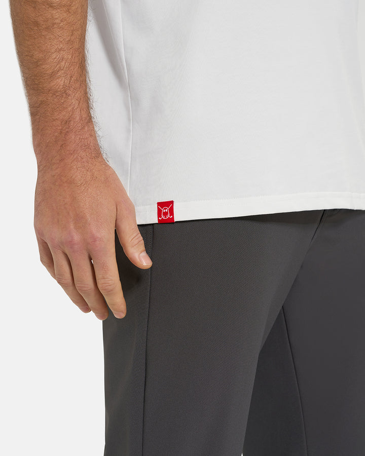 Bottom Closeup View of Optic White Ghost Golf Core Logo Tee on White Male Model with Ghost Icon Hit  #color_white