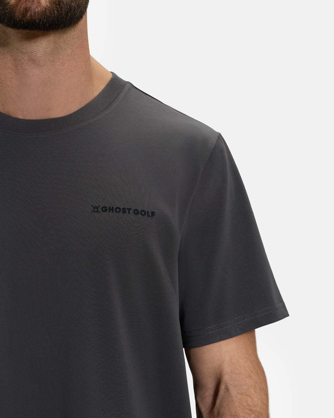 Closeup Front View of Iron Grey Ghost Golf Core Logo Tee on White Male Model #color_iron-grey