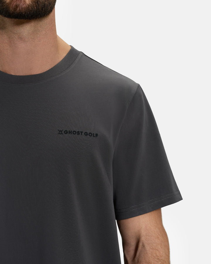 Closeup Front View of Iron Grey Ghost Golf Core Logo Tee on White Male Model #color_iron-grey