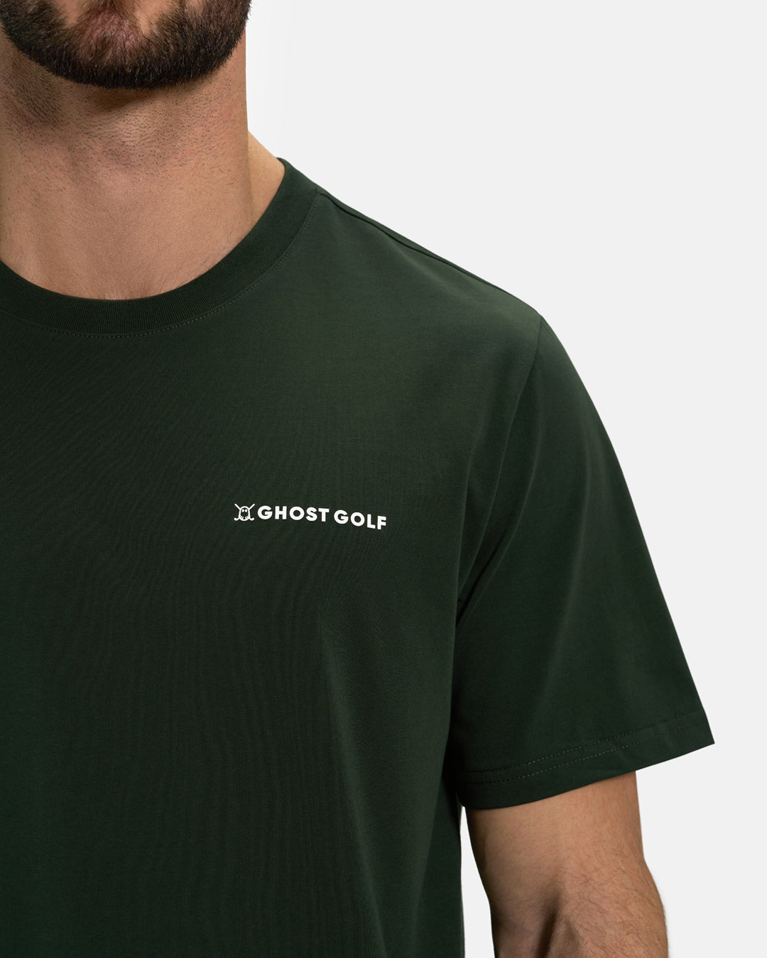 Closeup Front View of Forest Green Ghost Golf Core Logo Tee on White Male Model #color_forest-green