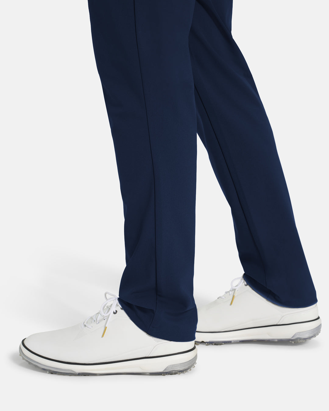 Bottom Closeup Side View of Navy Ghost Golf Core Pant on White male Model #color_navy