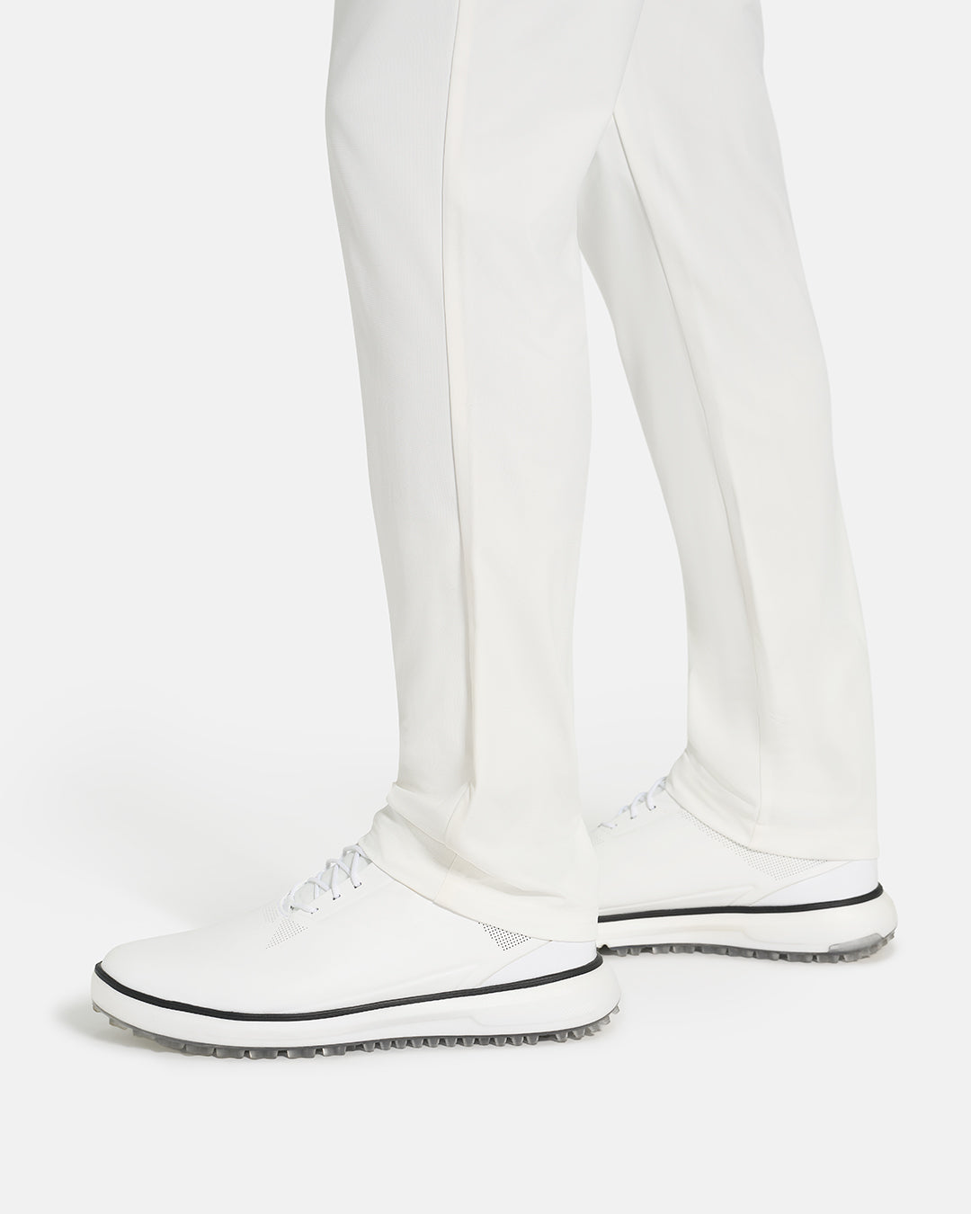 Bottom Closeup Side View of White Ghost Golf Core Pant on White male Model #color_white