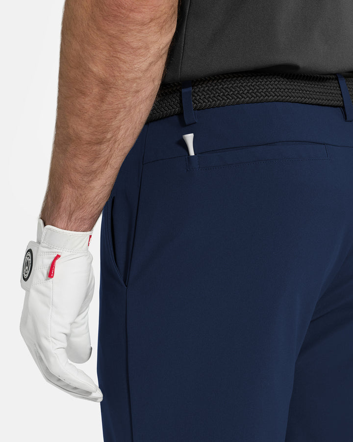 Closeup Back Navy of White Ghost Golf Core Pant on White Male Model #color_navy