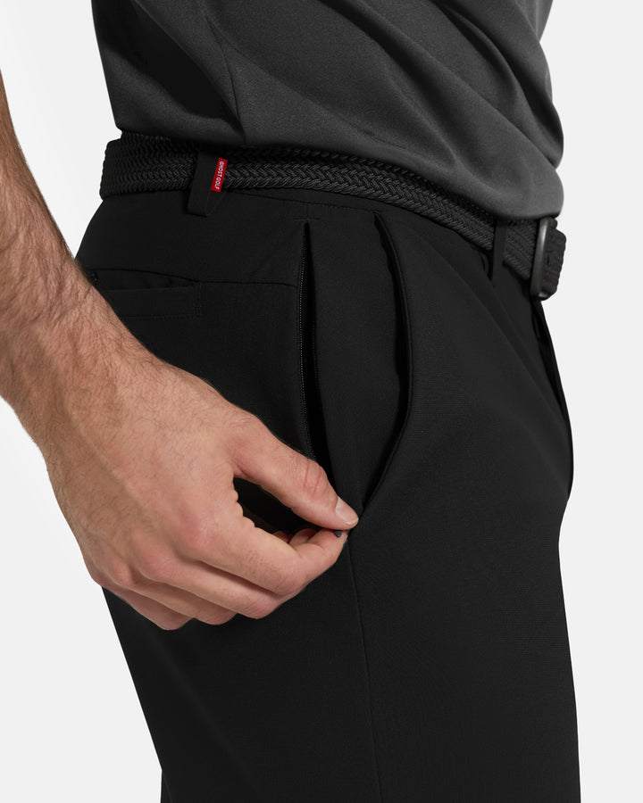 Closeup Side View of Black Ghost Golf Core Pant on White Male Model pulling down side zipper #color_black
