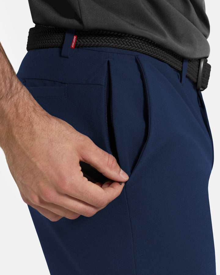 Closeup Side View of Navy Ghost Golf Core Pant on White Male Model pulling down side zipper #color_navy