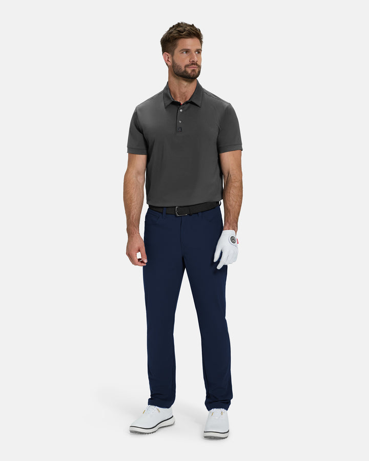 Full Body Front View of White Ghost Golf Core Pant on White Male Model wearing grey polo black belt white glove and white shoes #color_navy