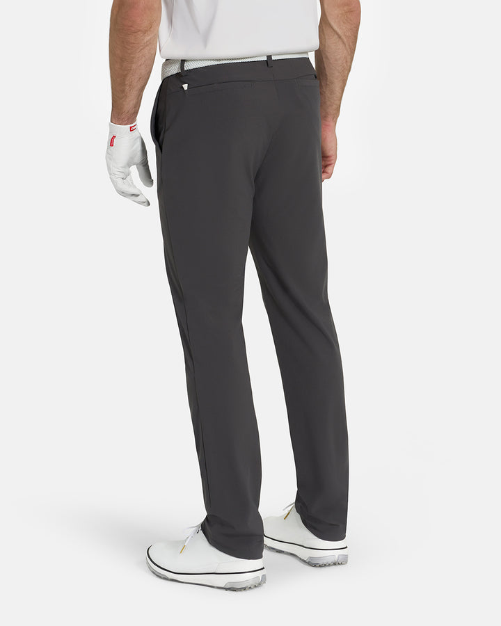 Back View of Iron Grey Ghost Golf Core Pant on White Male Model with White Shoes #color_iron-grey