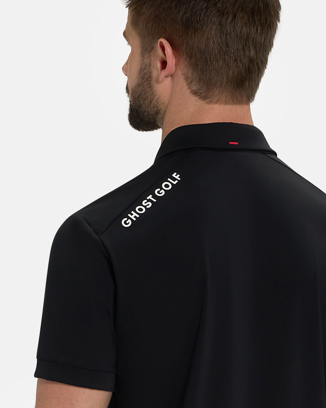 Back Closeup View of Black Ghost Golf Core Polo with Ghost Golf Logo on White Male Model #color_black