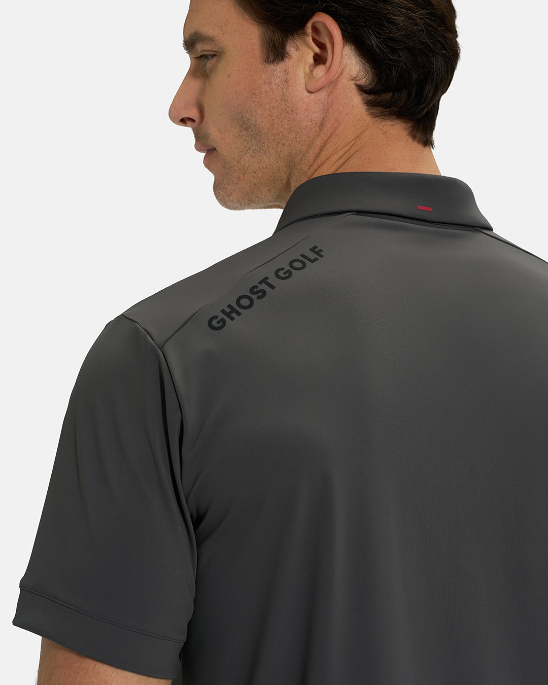 Back Closeup View of Iron Grey Ghost Golf Core Polo with Ghost Golf Logo on White Male Model #color_iron-grey