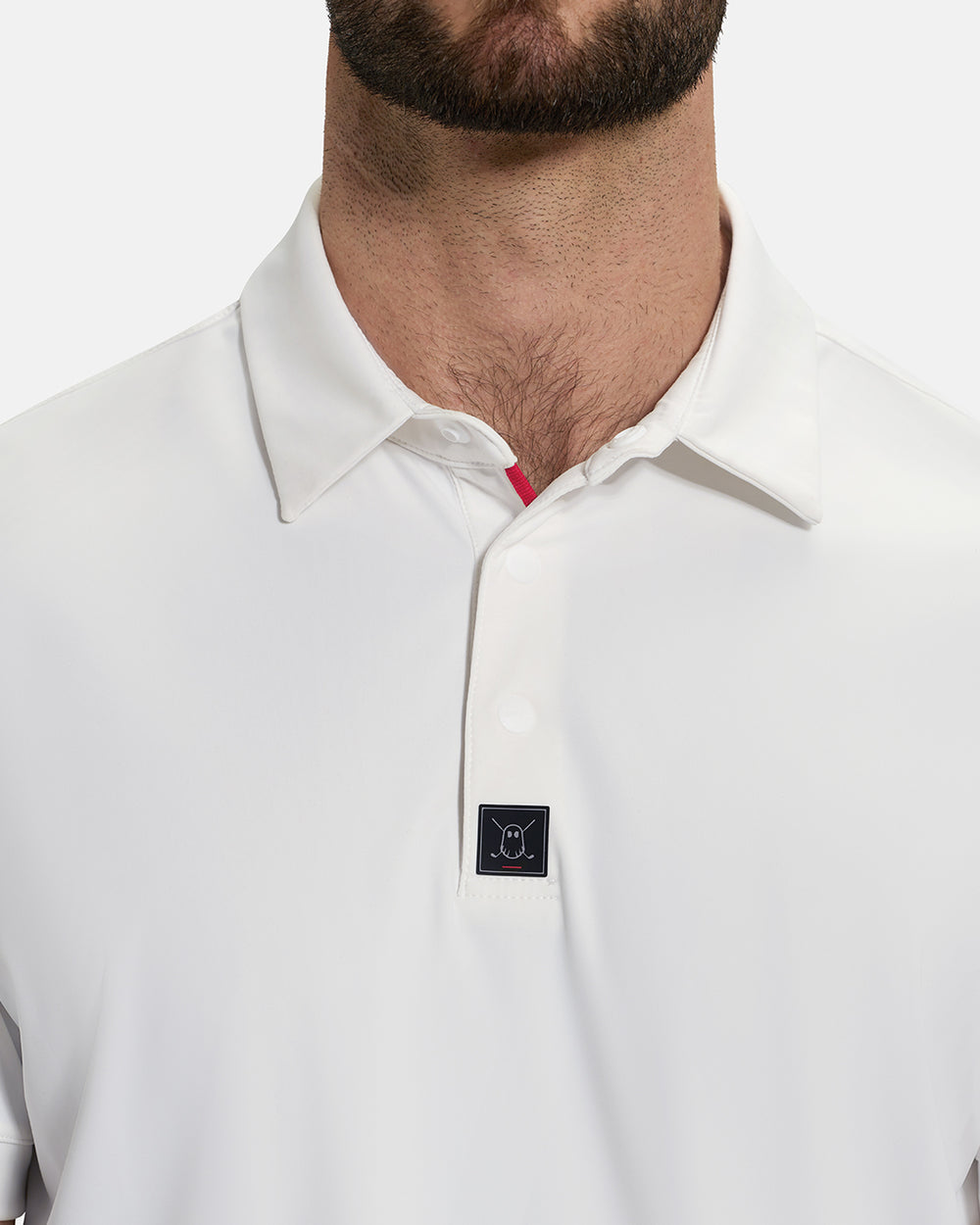 Front Closeup View of Optic White Ghost Golf Core Polo on White Male Model #color_white
