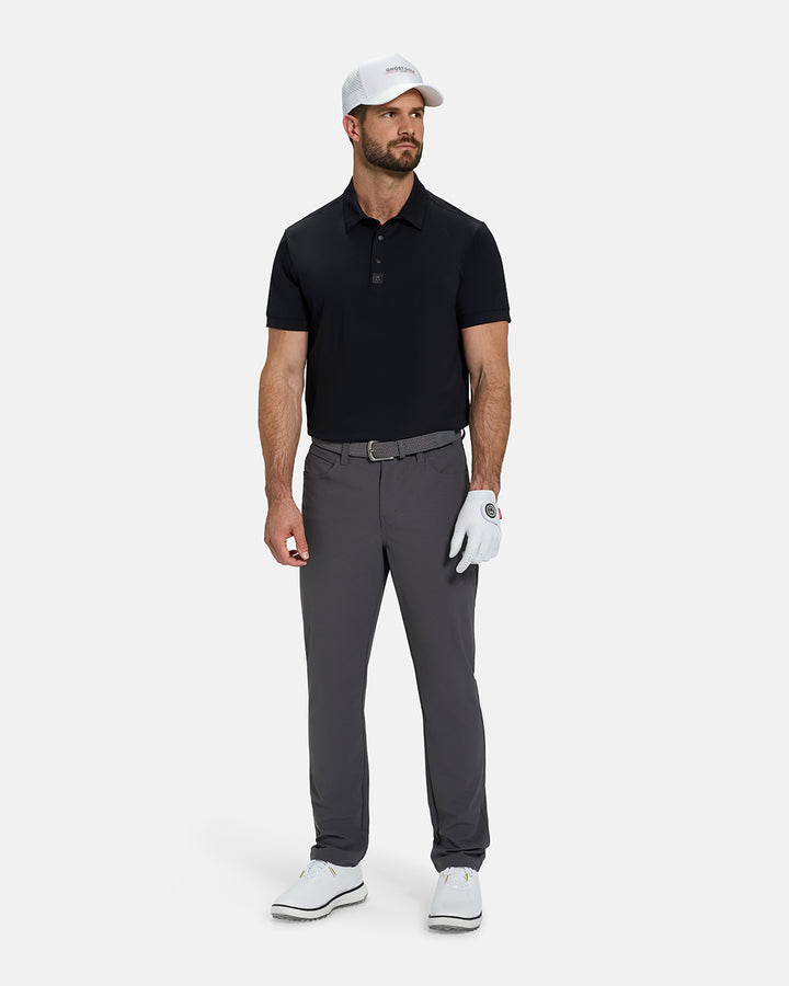 Full Body View of Black Ghost Golf Core Polo Tucked on White Male Model wearing grey pants white gloves grey belt white shoes and white hat #color_black