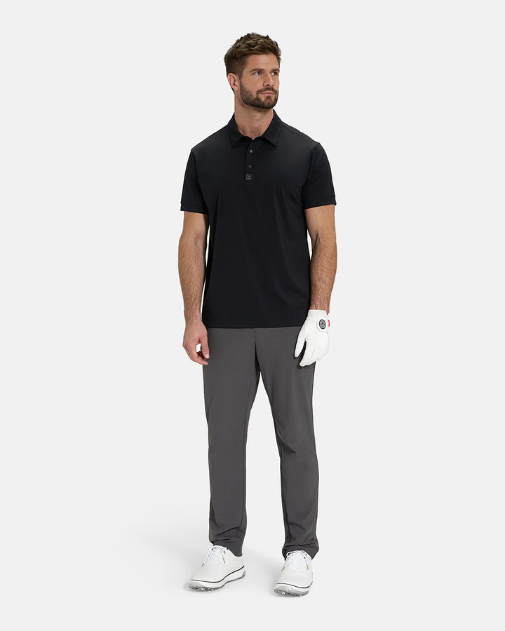 Full Body View of Black Ghost Golf Core Polo Untucked on White Male Model wearing grey pants white gloves grey belt white shoes #color_black