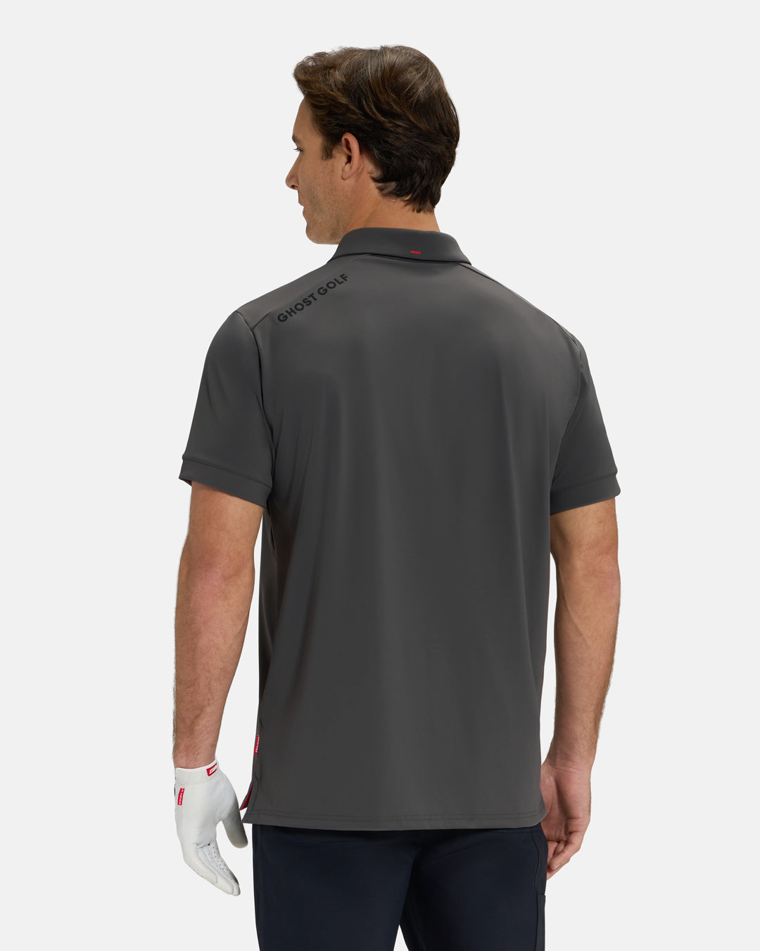 Back View of Iron Grey Ghost Golf Core Polo Untucked on White Male Model with Ghost Golf logo on back #color_iron-grey