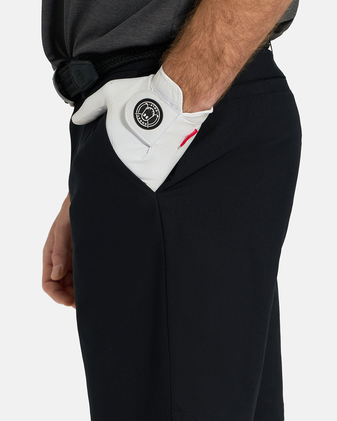 Side Closeup View of Black Ghost Golf Core Short on White Male Model with hand in pocket #color_black