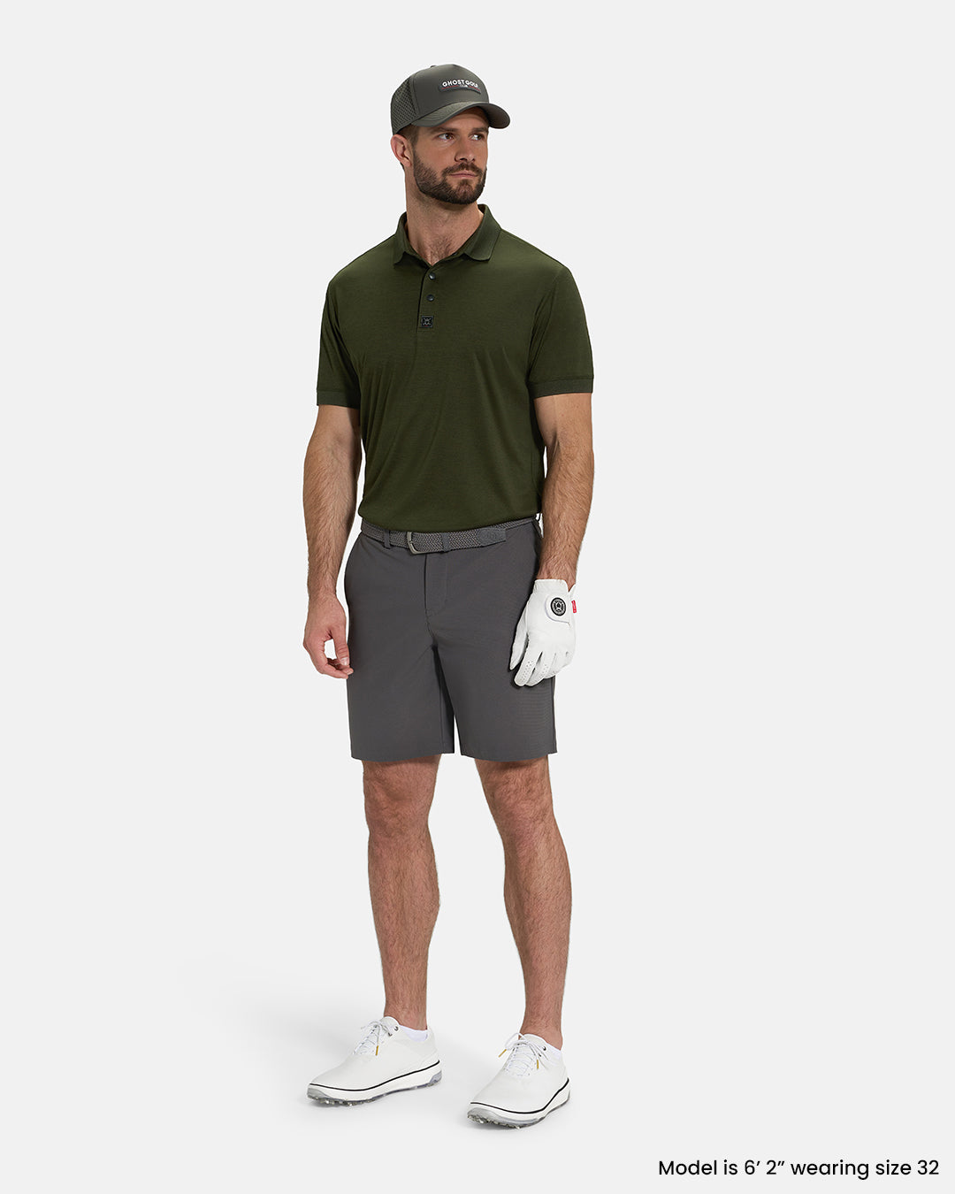 Full Body View of Iron Grey Ghost Golf Core Short on White Male Model wearing forest green polo white gloves grey belt white shoes and grey hat #color_iron-grey