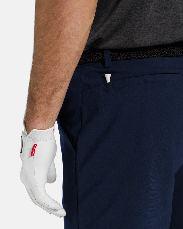 Closeup Back View of Navy Ghost Golf Core Short on White Male Model #color_navy