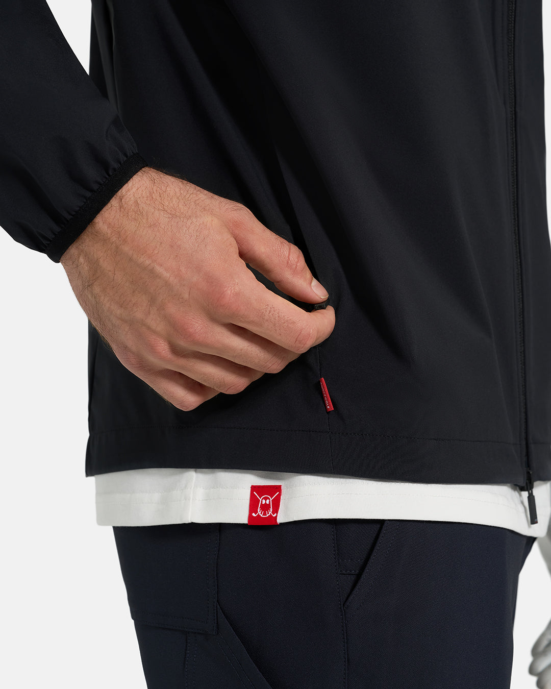 Zipper Pocket Side Closeup View of Black Ghost Golf Hooded Zip Shell Jacket  White Male Model #color_black