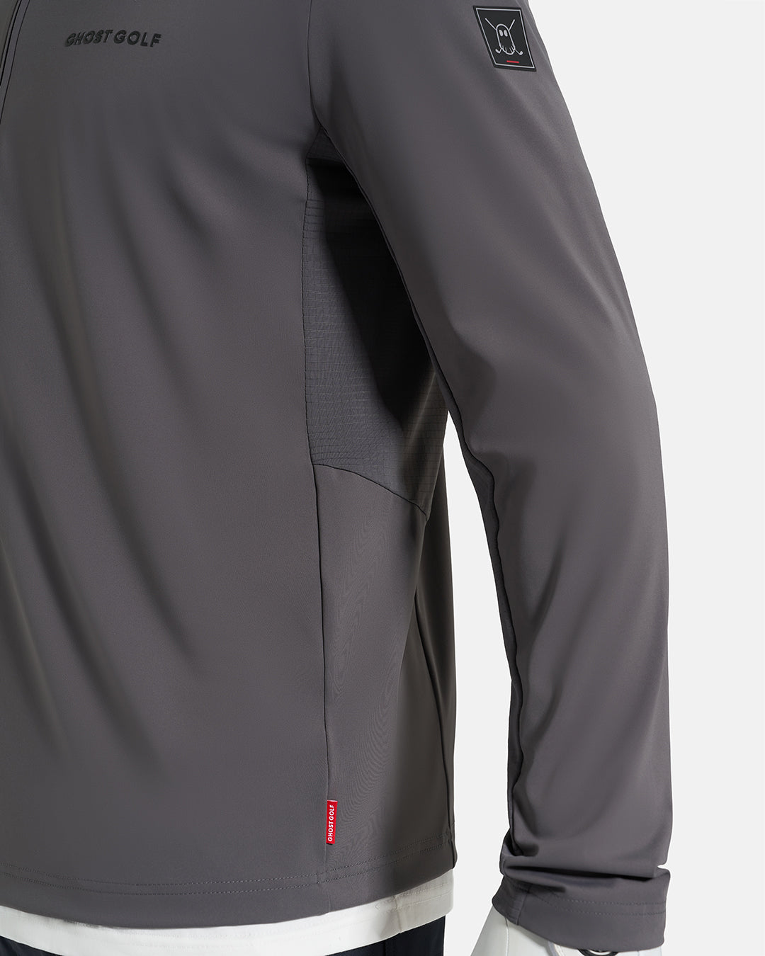 Side Closeup View of Iron Grey Ghost Golf Quarter Zip Mock Jacket with Ghost Golf Logo on White Male Model #color_iron-grey