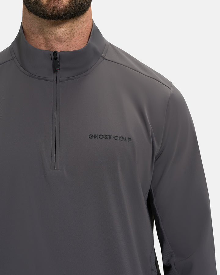 Front Closeup View of Iron Grey Ghost Golf Quarter Zip Mock Jacket with Ghost Golf Logo on White Male Model #color_iron-grey