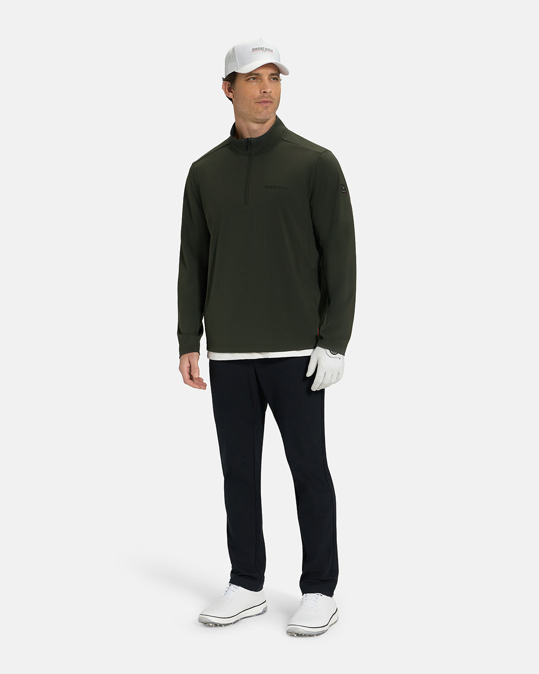 Full Body View of Forest Green Ghost Golf Quarter Zip Mock Jacket on White Male Model wearing black pants white glove white hat white shoes and white tee #color_forest-green