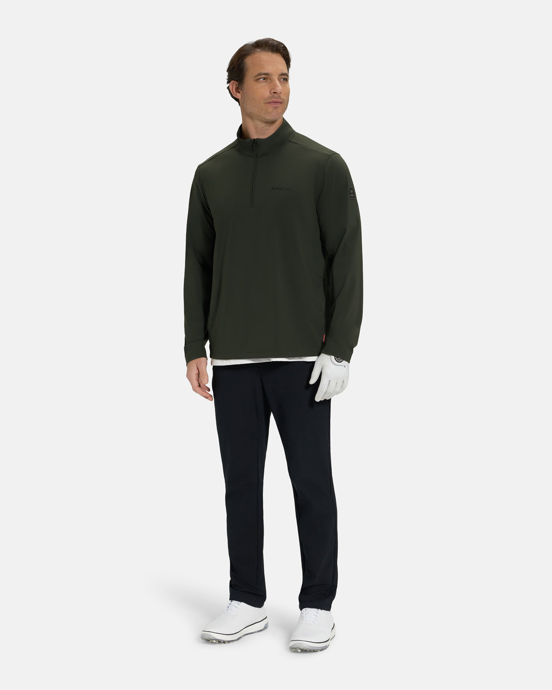 Full Body View of Forest Green Ghost Golf Quarter Zip Mock Jacket on White Male Model wearing black pants white glove white tee and white shoes #color_forest-green