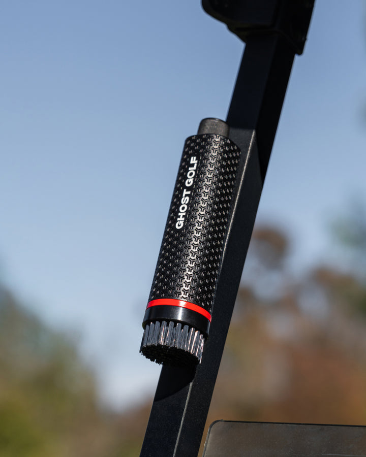Black Ghost Golf club and shoe cleaning brush with a magnetic back attached to the Golf Cart post #color_black